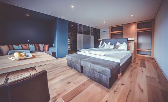 a large bed with a wooden headboard and footboard is in a room with blue walls at Spaces Hotel