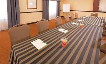 a long table with a black and gray striped tablecloth is set up for a meeting at Country Inn & Suites by Radisson, Baltimore North/White Marsh