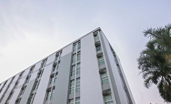 a modern , gray - and - white apartment building with large windows and balconies , under a cloudy sky at Verona Hplus Long Stay