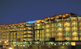 "a large building with multiple floors and balconies is lit up at night , with the word "" paul "" on top" at Landmark Resort