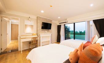 a modern bedroom with wooden floors , white walls , and large windows offering views of the outdoors at DoiTung Lodge
