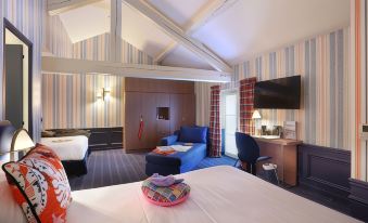 a modern hotel room with a striped ceiling , blue and pink accents , white bedding , and a comfortable bed at Hob le Cheval Blanc