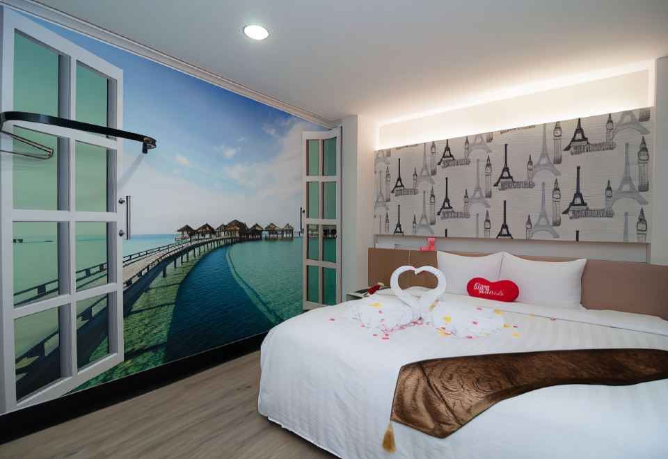 a bedroom with a large window overlooking a beach and a mural of a pier at 101 Hotel