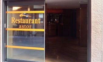 the entrance of a restaurant astor , with its glass door and the name displayed on the glass at Hotel Astor