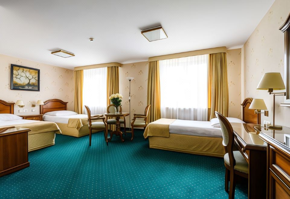 a hotel room with three beds , two of which are twin beds and one is a double bed at Hotel Boss