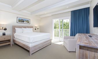 a spacious bedroom with a large bed , a couch , and a door leading to a balcony at Legacy Vacation Resorts-Indian Shores