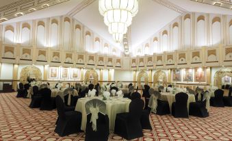 a large banquet hall with multiple tables and chairs set up for a formal event at Islamabad Marriott Hotel