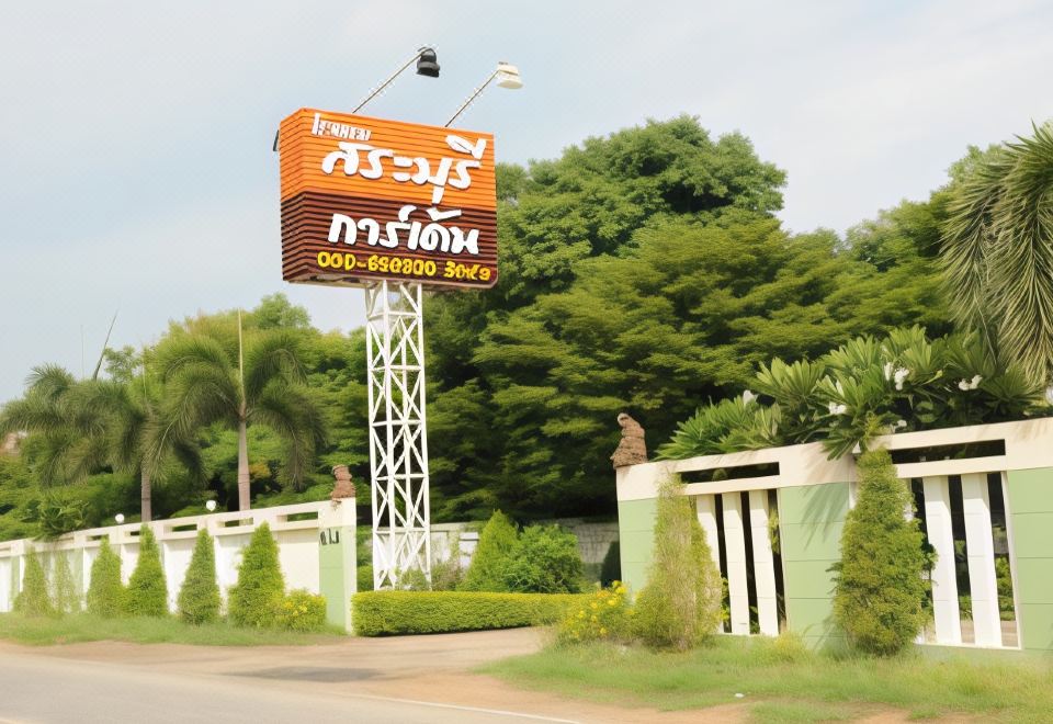 "a large sign with the words "" best central phuket "" prominently displayed on it , surrounded by greenery and trees" at Saraburi Garden Resort