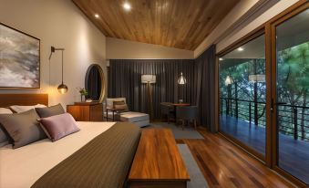 a modern bedroom with wooden ceiling , hardwood floors , and a large window overlooking the outdoors at Koanze Luxury Hotel & Spa