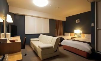 a modern hotel room with a bed , couch , and desk , along with other amenities such as a tv at Country Hotel Takayama