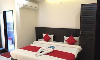 a neatly made bed with red and white sheets and pillows is shown in a hotel room at Holiday Inn