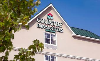 "a large building with a sign that reads "" country inn & suites "" prominently displayed on the side of the building" at Country Inn & Suites by Radisson, Baltimore North/White Marsh