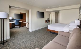 a hotel room with a king - sized bed , a flat - screen tv , a desk , and a chair at Delta Hotels Basking Ridge