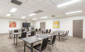 a conference room with multiple tables and chairs arranged for a meeting or training session at Quest Liverpool