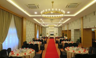 a large banquet hall with tables and chairs set up for a formal event , possibly a wedding reception at StarLodge