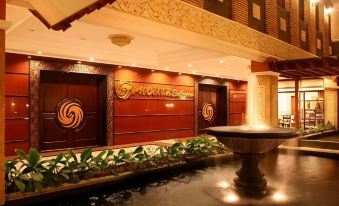 "a luxurious hotel entrance with a fountain and a sign that reads "" mahanaksha "". several doors leading to the building" at Luminor Hotel Jember by WH