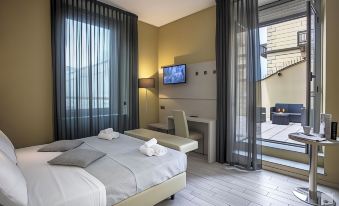a modern hotel room with a large bed , television , and balcony view , all decorated in neutral colors at Hotel Diplomatic