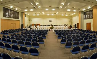 a large room with rows of chairs arranged in a semicircle , where a graduation ceremony is taking place at Hotel Marbella