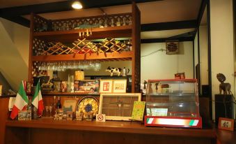 a small bar with various bottles and glasses , along with a variety of items on the counter at Flower Garden