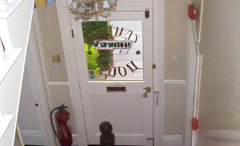 "a white door with a window that says "" welcome "" and "" jbl "" above it , along with a fire extinguisher on the left" at Diamonds Villa Near York Hospital