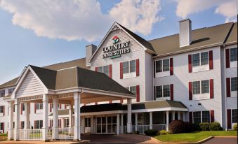"a large white building with a red roof and the words "" country inn & suites "" written on it" at Country Inn & Suites by Radisson, Rock Falls, IL