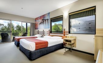 a hotel room with two beds , one on the left and one on the right side of the room at Kingfisher Bay Resort