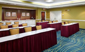 a large conference room with multiple tables and chairs arranged for a meeting or event at Staybridge Suites Pittsburgh Airport