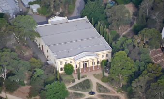 aerial view of a large , white building surrounded by trees and bushes in a city at Lyndoch Hill