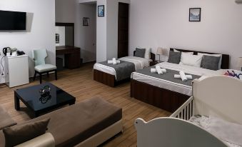 a modern hotel room with three beds , two of which are twin beds and one is a double bed at Hotel Old Town