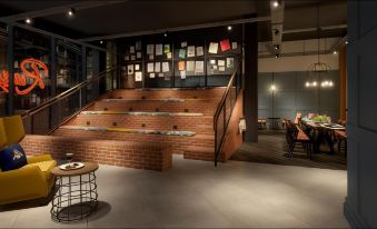 a brick staircase leading up to a restaurant with tables and chairs , creating an inviting atmosphere at Hotel Brooklyn Manchester