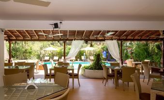 an outdoor dining area at a resort , with tables and chairs arranged for guests to enjoy their meal at Casablanca