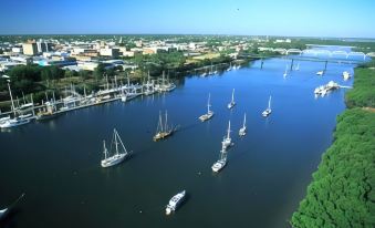 aerial view of a large group of boats docked in a body of water , surrounded by buildings at Boulevard Lodge Bundaberg
