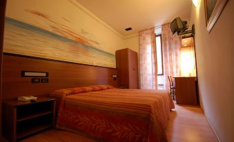a hotel room with a bed , television , and a large painting on the wall , along with wooden flooring and furniture at Hotel Leonardo