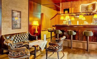 a cozy living room with a wooden bar and leather chairs , creating a warm and inviting atmosphere at Hotel National