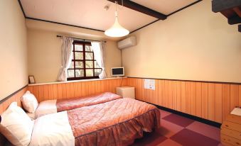 a small bedroom with two beds , one on the left and one on the right side of the room at Flower Garden