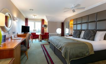 a hotel room with a comfortable bed , a tv , and a desk , all in a modern style at The Park Royal Hotel & Spa