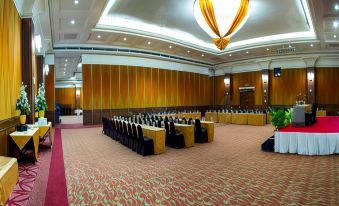 a large conference room with multiple rows of chairs arranged in a semicircle , ready for a meeting at Grand Pasundan Convention Hotel