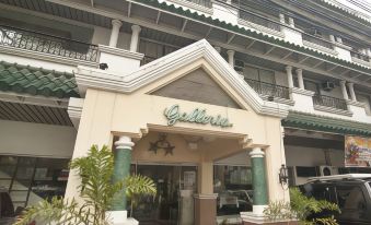 "a building with a sign that reads "" galeria "" in front of it , surrounded by greenery" at Hotel Galleria