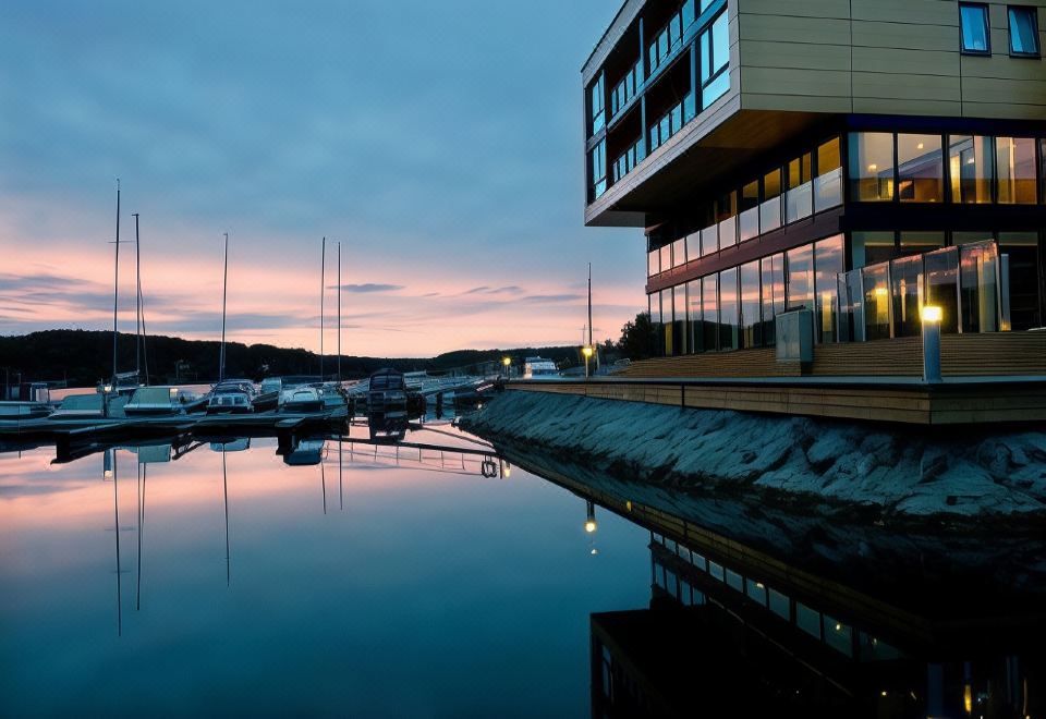 a large building with a boat dock in front of it , reflecting in the water at Son Spa, an Ascend Member