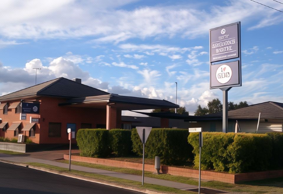 "a building with a sign that says "" anglo - australian square boutique "" and a street lamp" at Adelong Motel