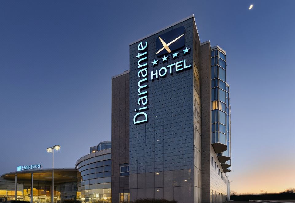 "a large hotel building with a sign that reads "" diamante hotel "" prominently displayed on the front of the building" at Hotel Diamante