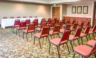 a conference room with rows of red chairs arranged in a semicircle , ready for a meeting at Comfort Suites Gadsden Attalla