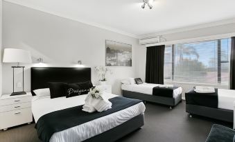 a modern hotel room with two beds , white bedding , and black accents , along with a window and a painting on the wall at Airport Hotel Sydney