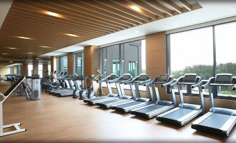 a row of treadmills lined up in a gym , with several people working out on them at Sun Valley Hotel