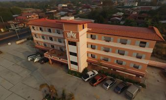 aerial view of a large building with a parking lot and cars parked in front at Thatphanom View Hotel