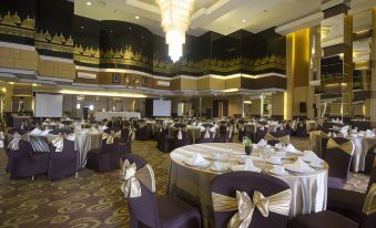 a large , elegant dining room with tables and chairs set up for a formal event at Tjokro Hotel Klaten