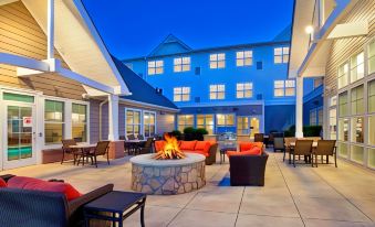 an outdoor courtyard with a fire pit surrounded by chairs and tables , creating a cozy atmosphere at Residence Inn Bridgewater Branchburg