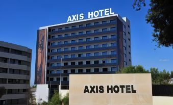 "a large hotel with a sign that says "" axis hotel "" in front of it , surrounded by trees" at Axis Porto Business & Spa Hotel