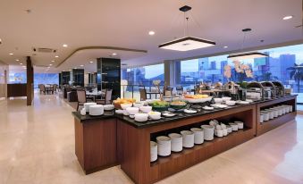 a large , modern dining area with a variety of food and beverages on display in a buffet - style setting at ASTON Imperial Bekasi Hotel & Conference Center