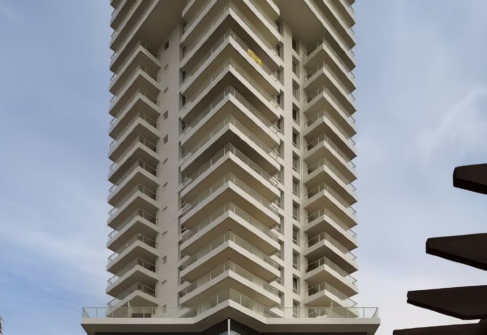 a tall , modern building with many balconies and a blue sky in the background at David Tower Hotel Netanya by Prima Hotels - 16 Plus